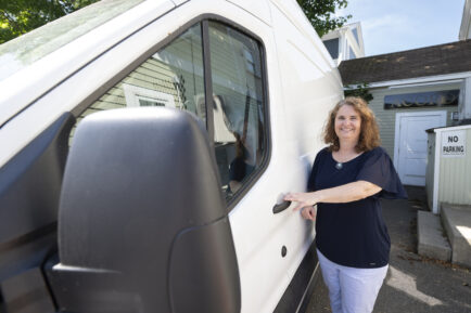 Acord Food Pantry Executive Director, Stacey Verge, poses with the pantry's new van